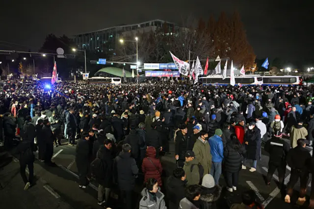 Large crowds have gathered in Seoul - people can be seen waving flags