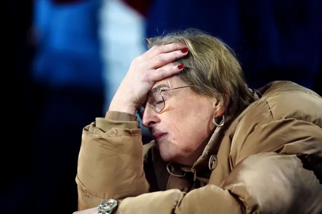 West Ham fan holds her head in her hand