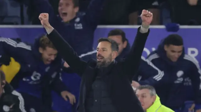 Van Nistelrooy throws his arms above his head in celebration