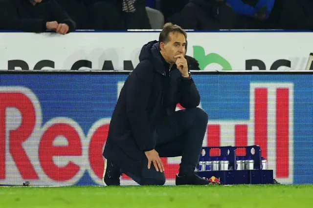 Lopetegui kneels on the floor with his hand to his face