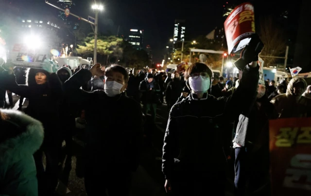 People react outside National Assembly, after South Korean President Yoon Suk Yeol announced that he will lift the martial law