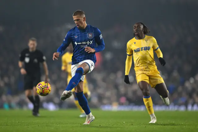 Harry Clarke of Ipswich Town passes the ball under pressure from Eberechi Eze of Crystal Palace