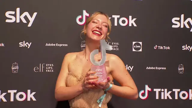 Maddi Neye-Swift smiles with her award