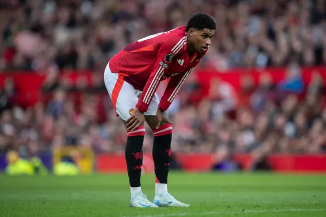 Marcus Rashford stands on his haunches