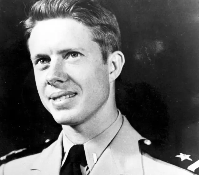 A black-and-white photo of young Jimmy Carter in a navy uniform