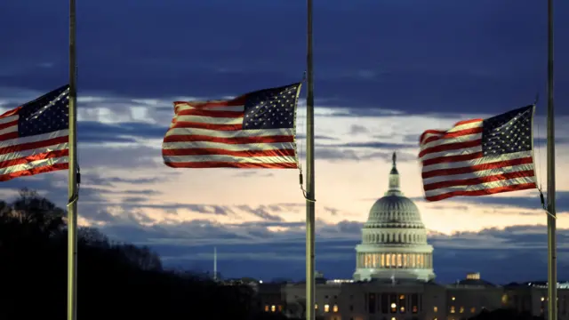 With the US. Capitol in the distance, flags fly at half-staff at the Washington Monument on the National Mall following the death of former U.S. President Jimmy Carter, in Washington, U.S., December 30, 2024.