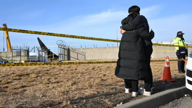 Mourners hug outside Muan airport