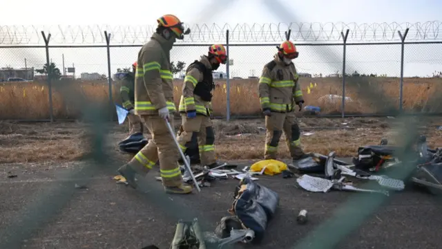 Recovery teams work at the scene where a Jeju Air Boeing 737-800 series aircraft crashed and burst into flames at Muan International Airport