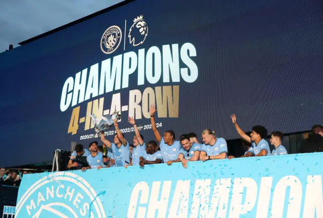 Manchester City players celebrate during their victory parade for their fourth Premier League title in a row.