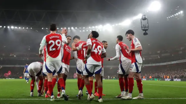 Arsenal players celebrate after scoring against Ipswich Town