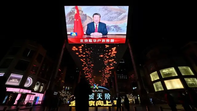 A broadcast of Xi Jinping is screened in Beijing