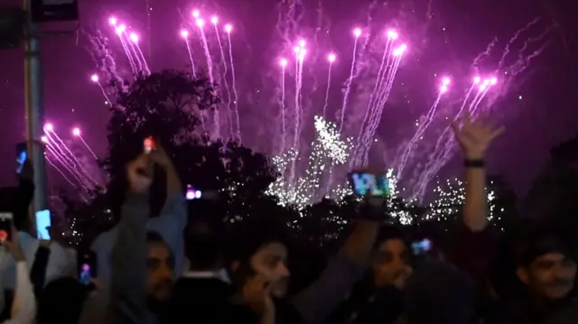 People celebrate the arrival of the new year with a fireworks display in Karachi, Pakistan