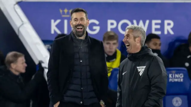 Ruud van Nistelrooy smiles with fourth official