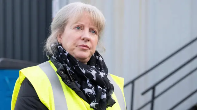 Shona Robison wearing a high viz vest and a black patterened scarf