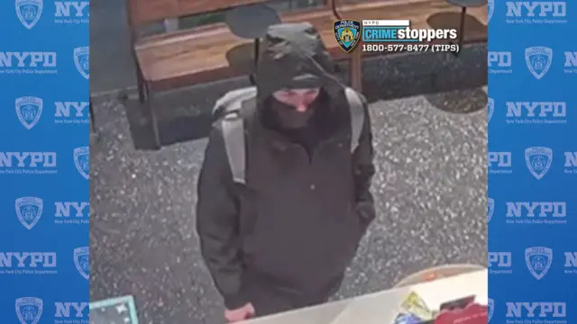 Security camera video of a man in a hoodie with a covering over his face