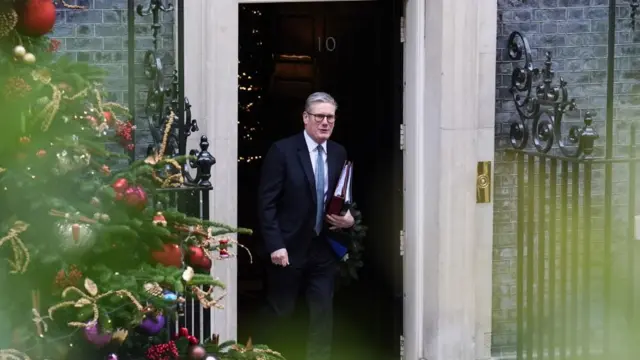 Keir Starmer leaving Downing Street with Christmas Tree in the foreground