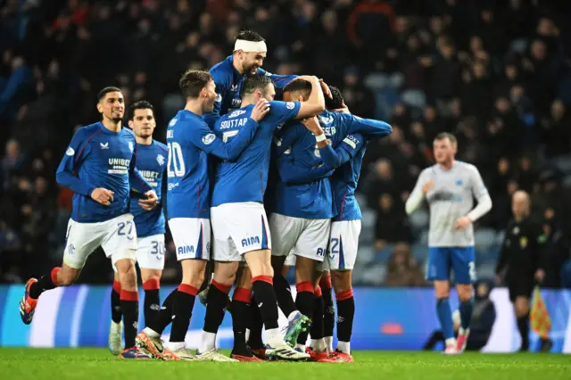 The Rangers players celebrate as Dessers makes it 5-0