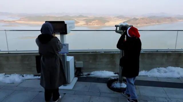 A picture taken last week shows people in South Korea looking at North Korea's propaganda village on the border of the two countries