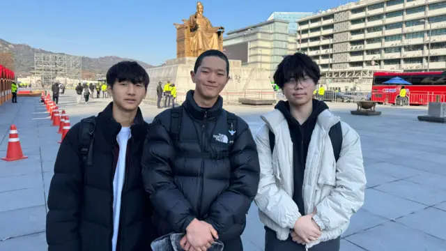 Kwon Ho (middle) pictued with friends at Gwanghwamun, the main square in Seoul