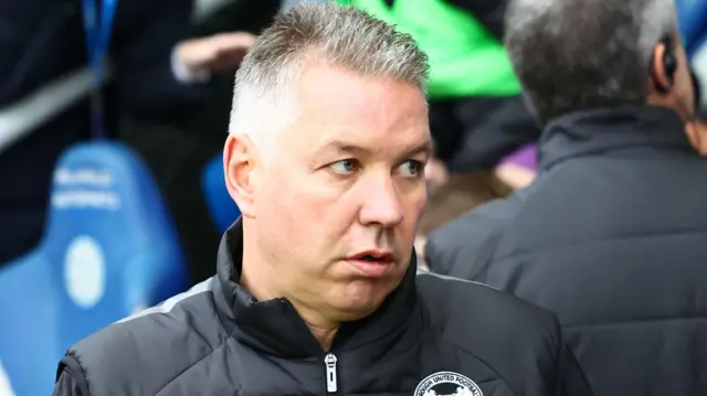 Peterborough boss Darren Ferguson looks on from the touchline.