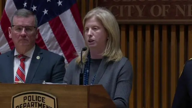 Jessica Tisch speaking into microphone while standing behind a podium with the police department badge on it