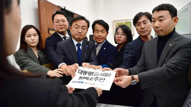 Lawmakers of the main opposition Democratic Party and other minor opposition parties submit a bill to impeach President Yoon Suk Yeol to the bills office at the National Assembly in Seoul