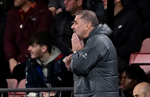 Ange puts his hands to his mouth in disbelief