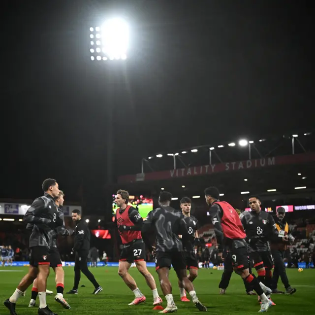 Bournemouth players warm up under the floodlights