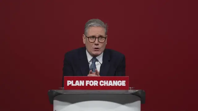 Prime Minister Keir Starmer delivers his 'Plan for Change' speech in front of a blank red wall