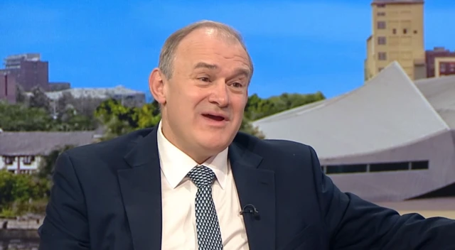 Headshot of Ed Davey talking with his mouth slightly open