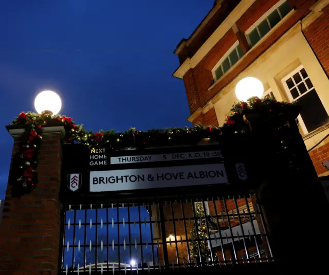 Craven Cottage gates with a board showing the next home game