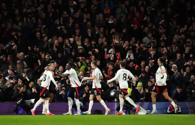 Fulham players congratulate Pereira after he forces an own goal