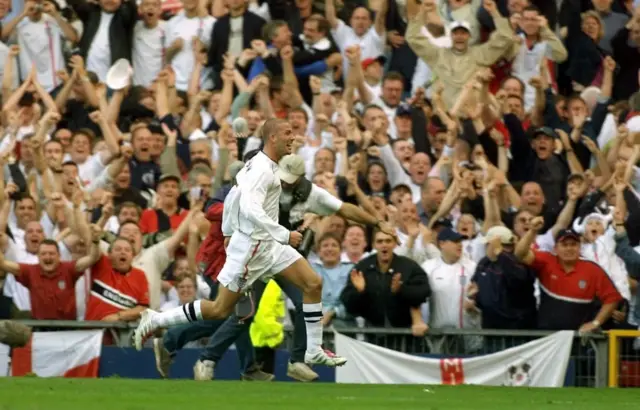 David Beckham celebrates scoring against Greece in 2001