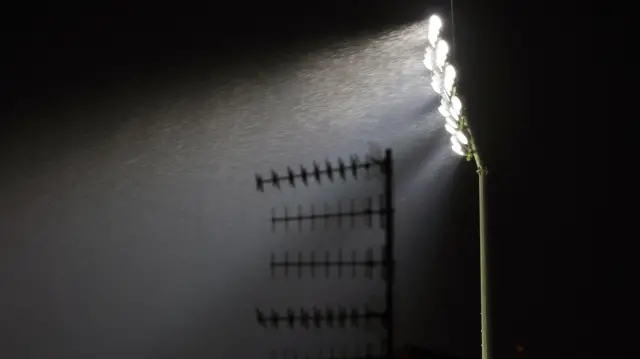 A floodlight and rain at Turf Moor