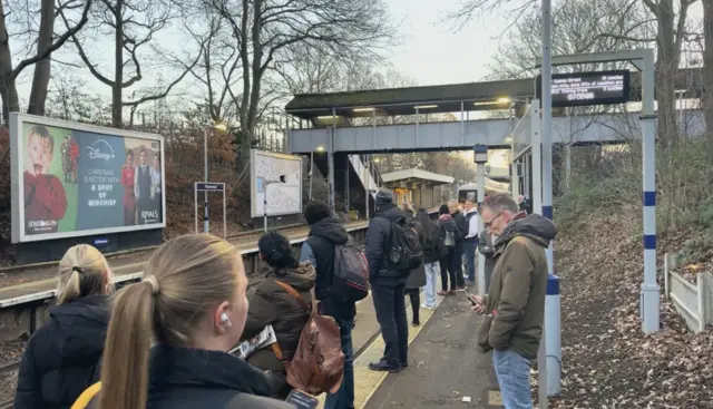 Passengers waiting on a train platform