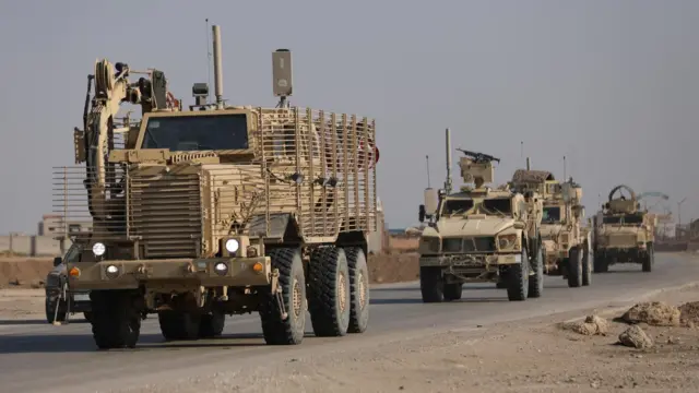 U.S. military vehicles drive in Hasaka, Syria