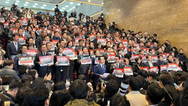 Opposition lawmakers stood in line, chanting "Impeach! Impeach!"