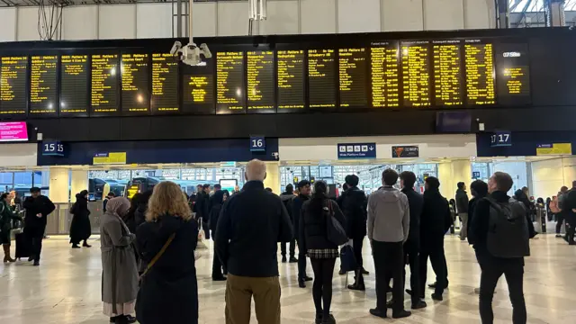 Departure board at Waterloo showing delays