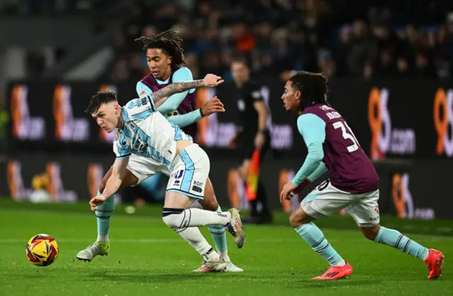 Ben Doak, of Middlesbrough is put under pressure by Bashir Humphreys and Luca Koleosho of Burnley