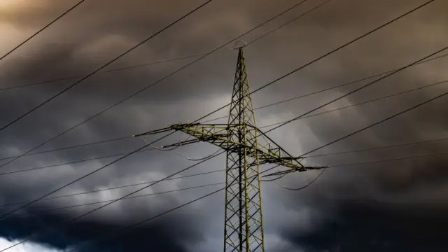 Electricity pylon with dark clouds in the background