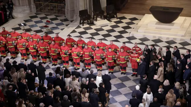 French firefighters attend the reopening ceremony of the Notre Dame de Paris Cathedral, following the 2019 fire, in Paris