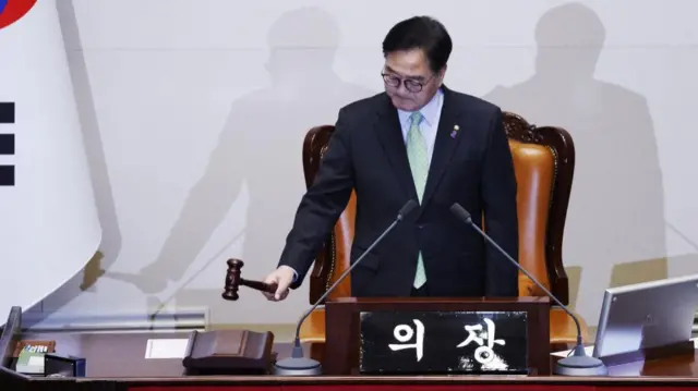 South Korean National Assembly Speaker Woo Won-shik bangs the gavel to indicate the start of the plenary session for the impeachment vote of President Yoon Suk Yeol at the National Assembly in Seoul, South Korea, 07 December, 2024.