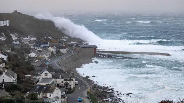 An enormous wave crashed over the headland in Sennen Cove.