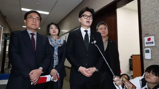 Han Dong-hoon (R), the leader of the ruling People Power Party, talks to reporters at the National Assembly