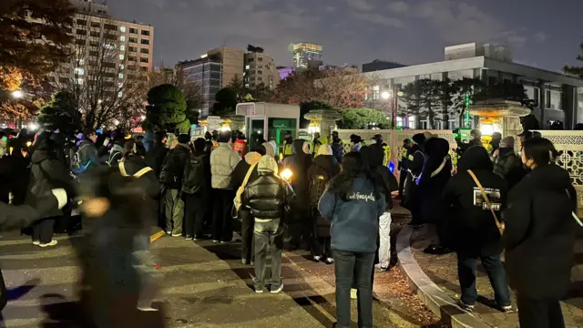 Group of South Korean protesters stand outside the National Assembly as MPs vote to impeach president Yoon