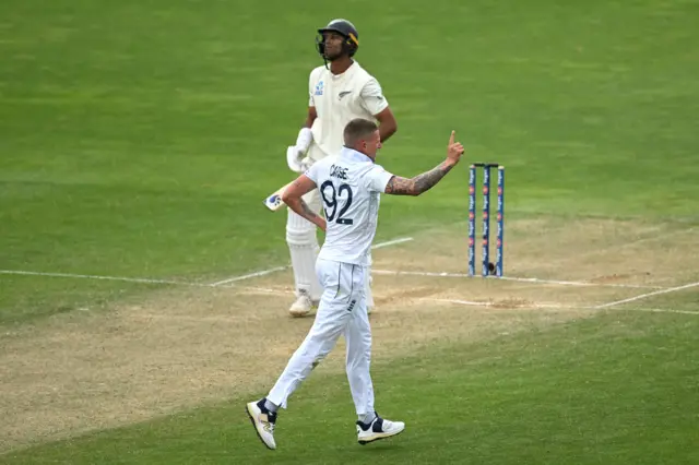 Brydon Carse celebrates the wicket of Rachin Ravindra