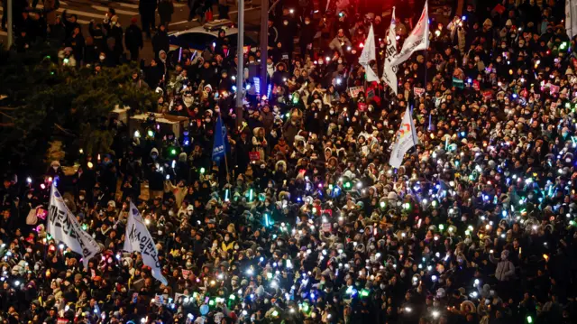 Protesters take part in a rally calling for the impeachment of South Korean President Yoon Suk Yeol, who declared martial law, which was reversed hours later, near the National Assembly in Seoul, South Kore