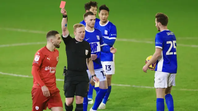 Barnsley's Adam Phillips is shown a red card