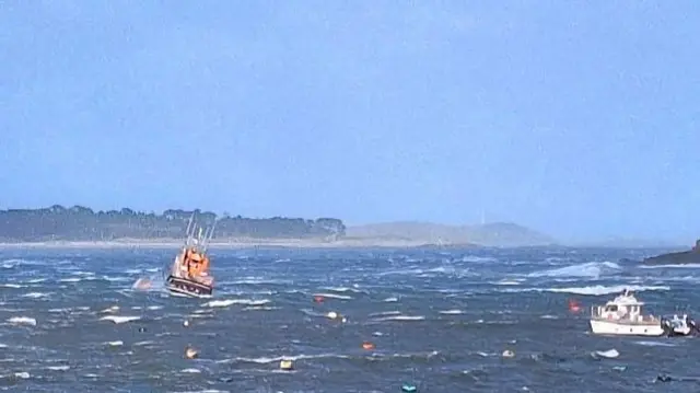 Moored boats battling the waves in the Isles of Scilly