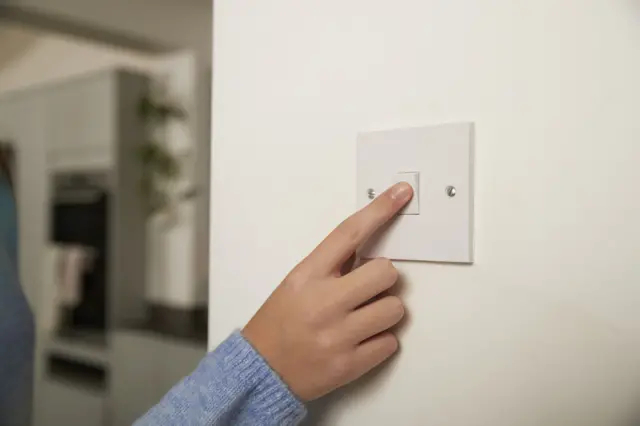 Hand on lightswitch